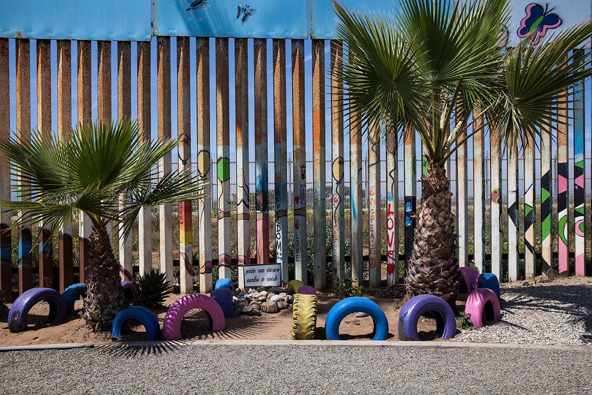 Part of the binational garden with native plants is maintained on both sides of the border fence...