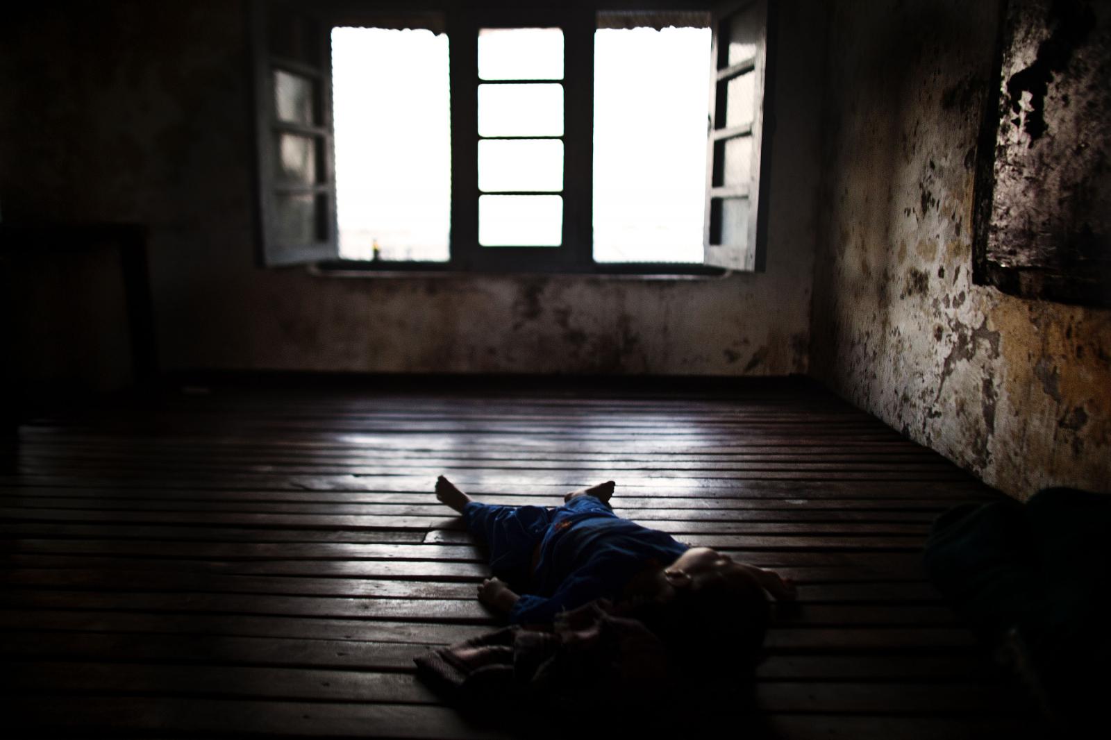 Chronicles of the monsoon - A children sleeps in a school after heavy floods forced...