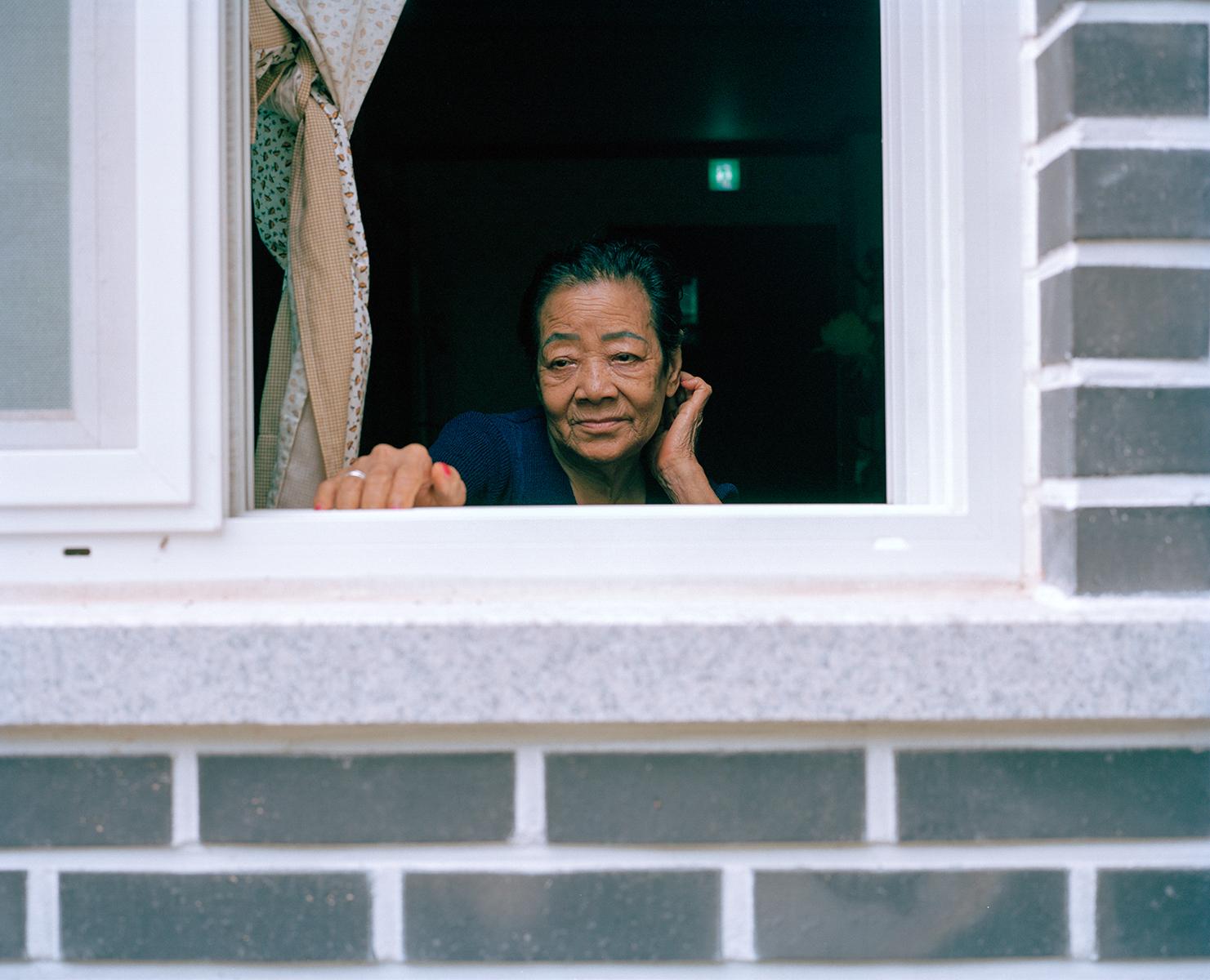 Kim Hwa Seon Halmoni looking out, House of Sharing, Gwangju, South Korea, 2010