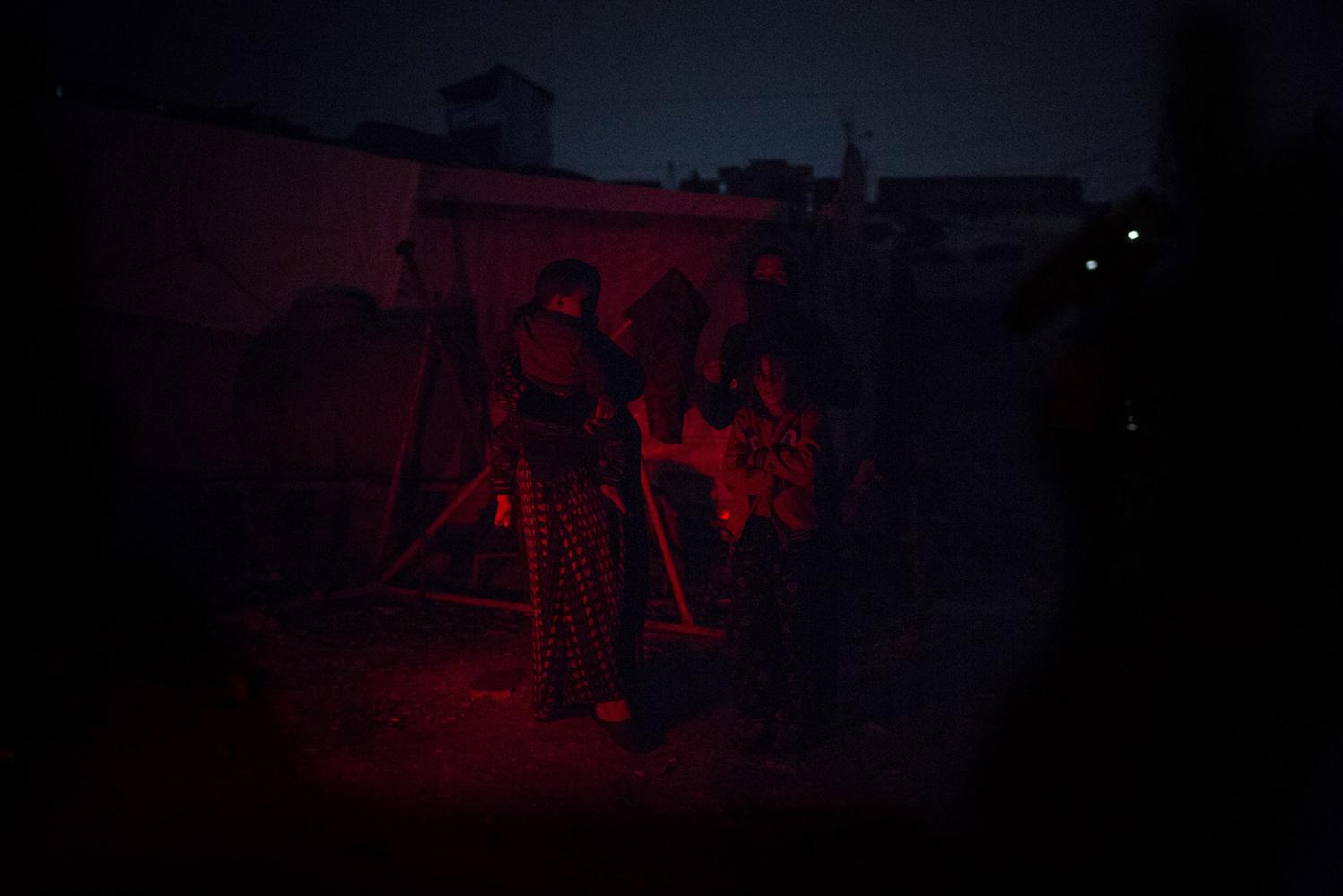 Storm - A Syrian family stands waiting to be realocated after...