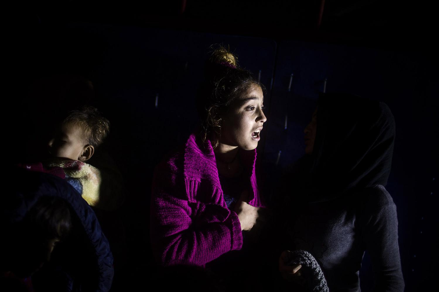 Storm - A Syrian refugee is seen inside a truck on her way to a...