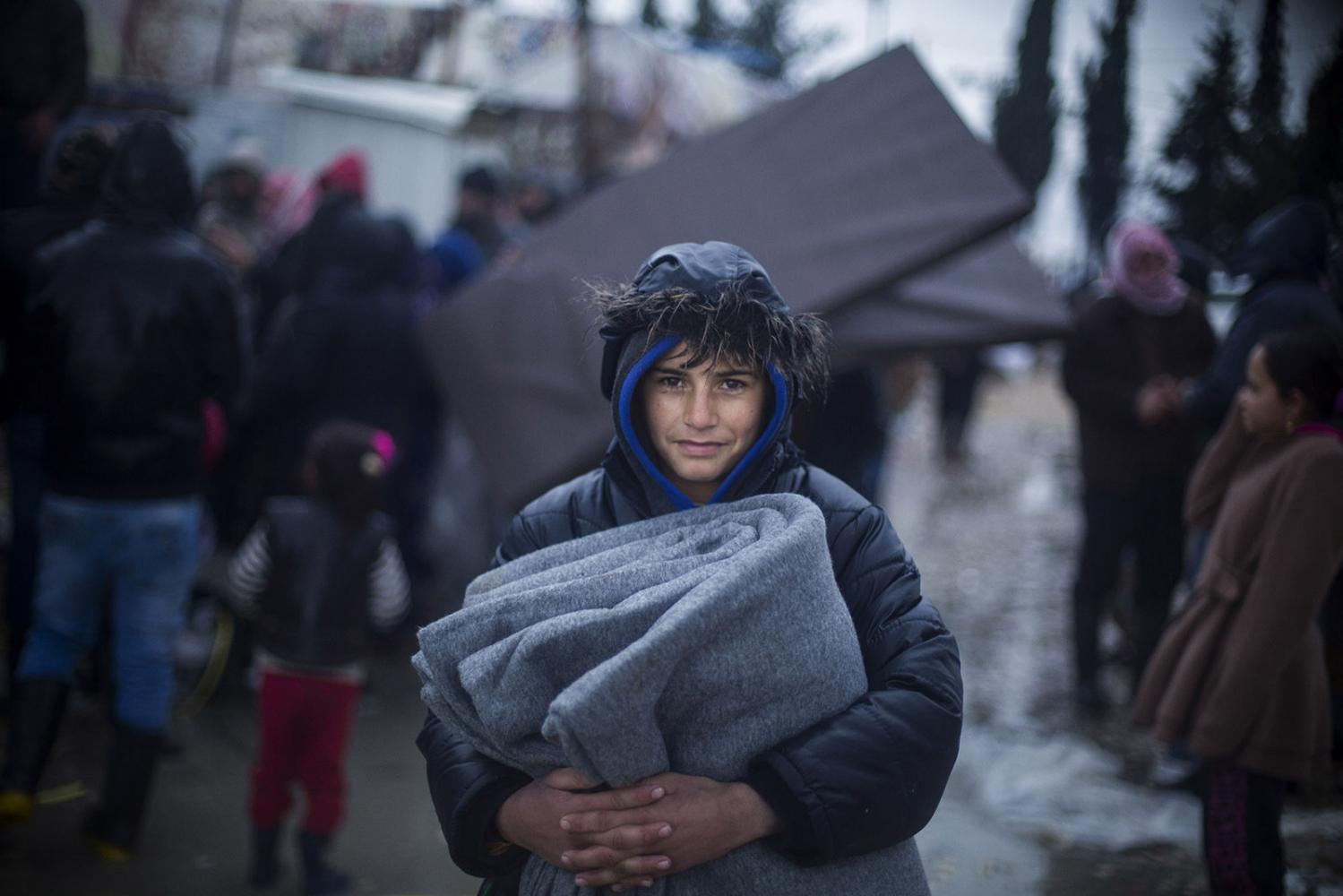 Storm - Mohamed, a young refugee from Deir ez-Zor carries...