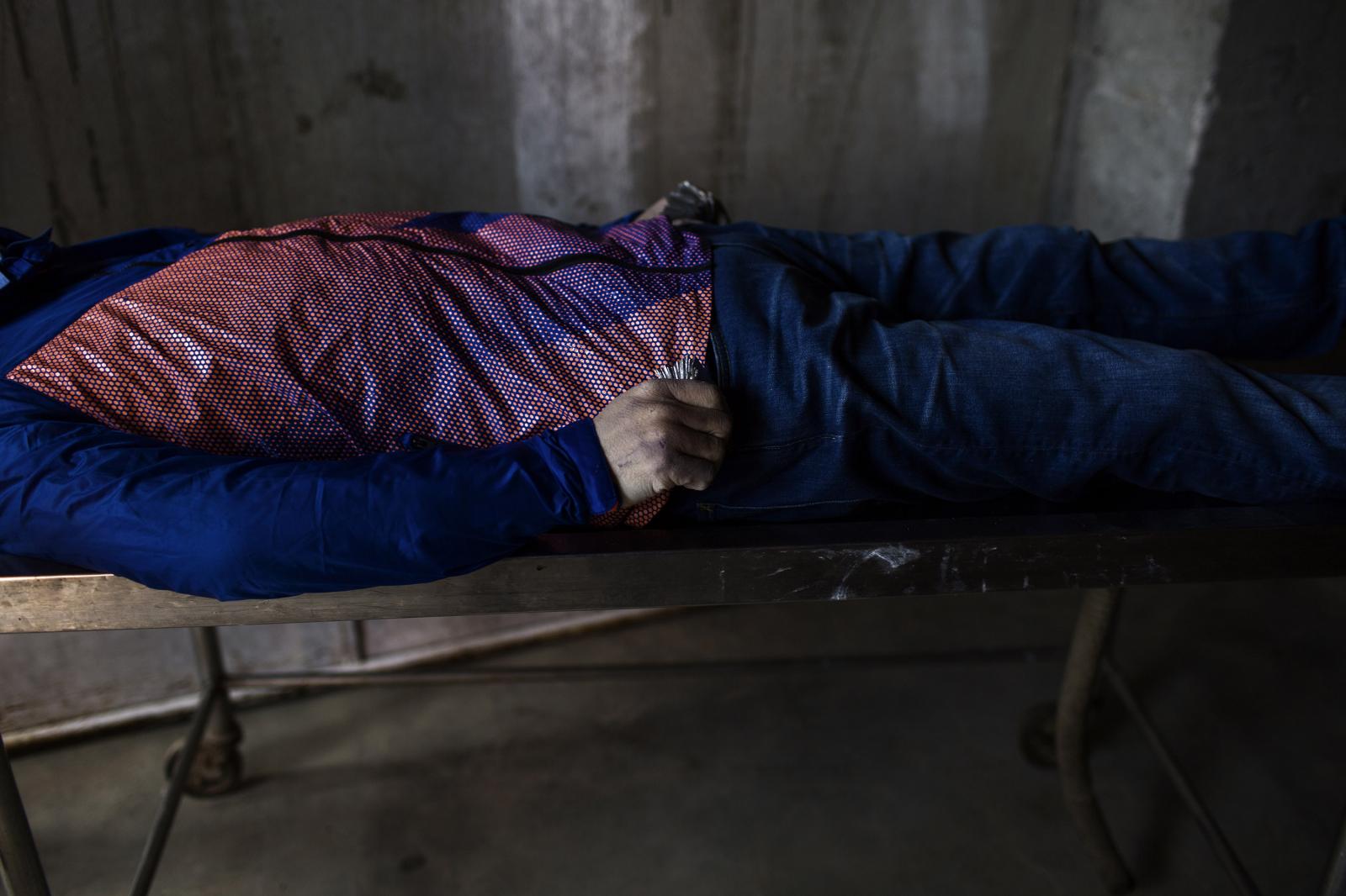 Nepal: Aftermath - A dead Japanese body lies on a stretcher at the Teacher...