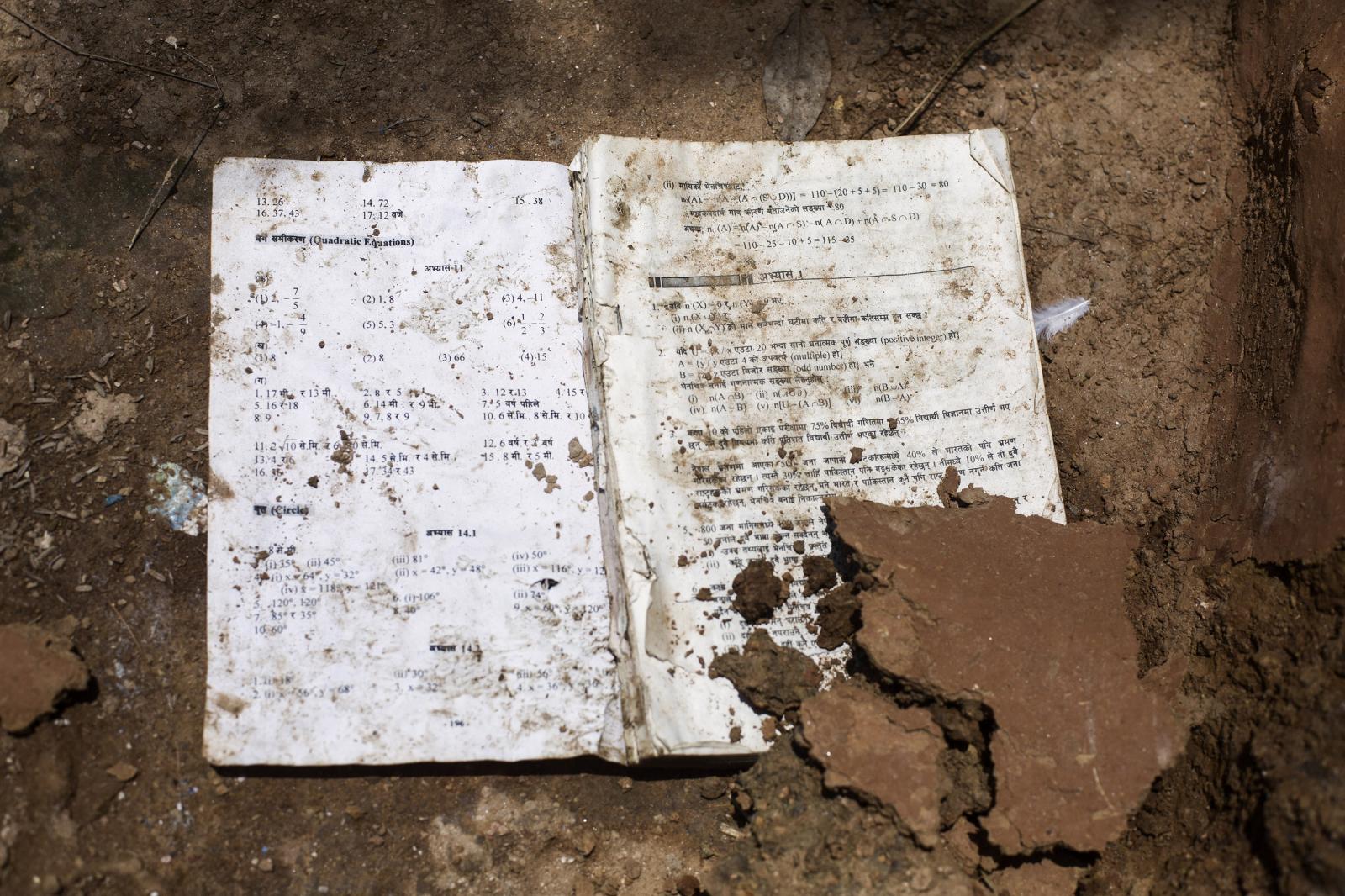 Nepal: Aftermath - A damaged school notebook is seens at the floor in...