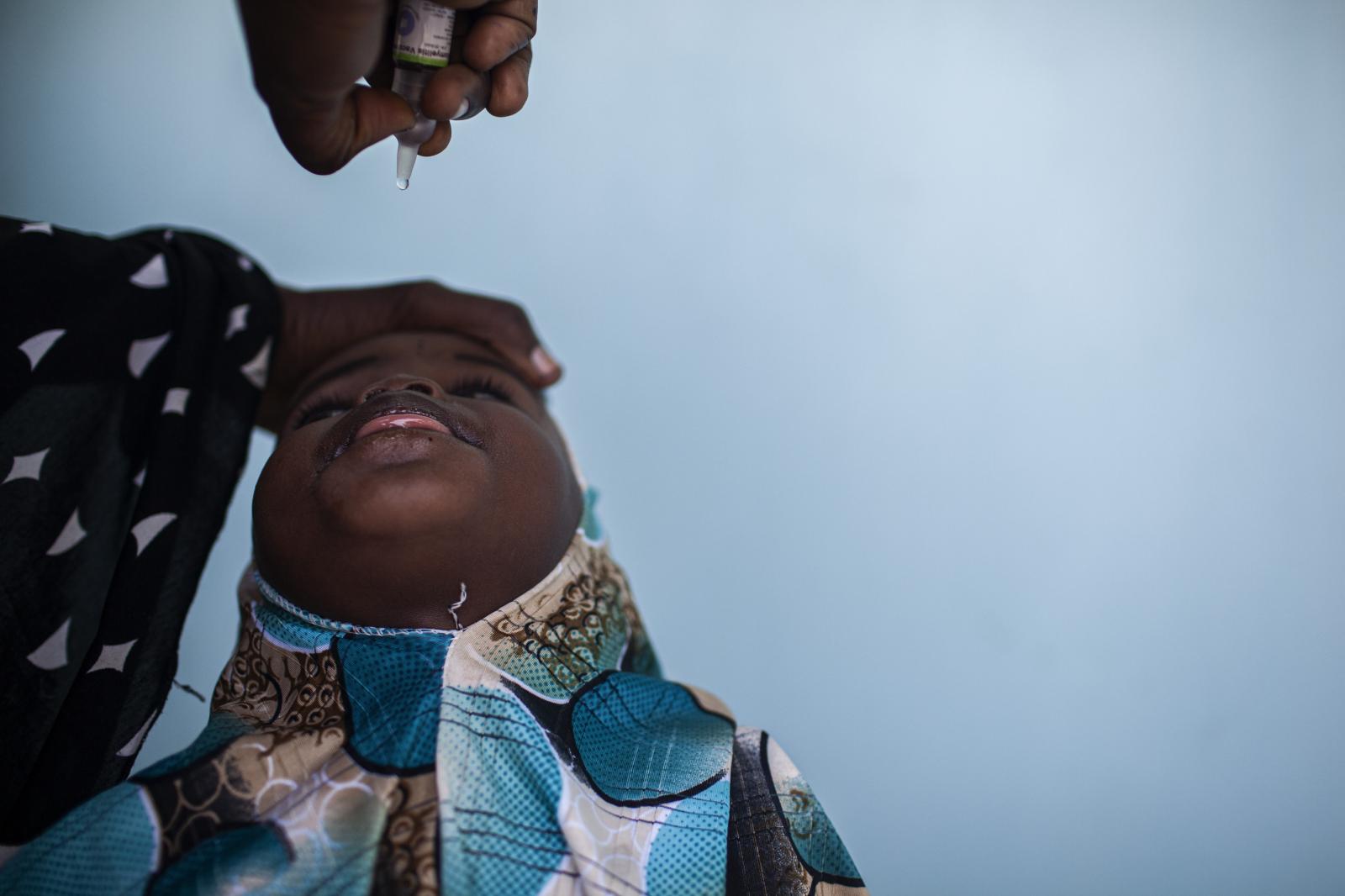 Polio Nigeria - A girl gets vaccinated during during the national...