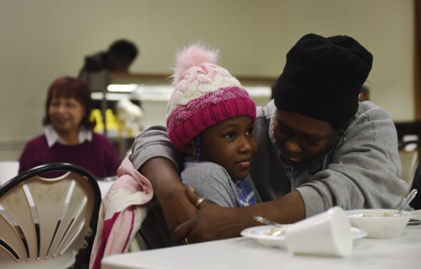 Elisa Wright embraces her niece Jarya Williams, 7, at the Poor Man&#39;s Breakfast on Monday, Jan. 20, 2020, at St. Luke&#39;s United Methodist Church. &quot;We come to these events to support the community because they (the community) will always be our family,&quot; Wright said.