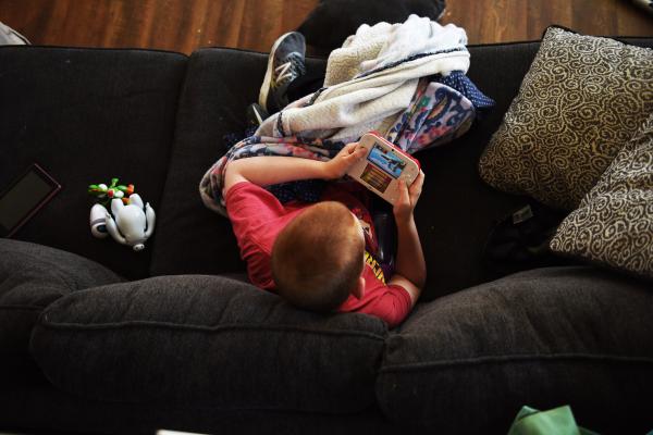 Image from Editorial - Logan Arnett, 10, plays on his Nintendo 2DS game system...