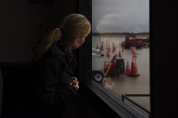 Editorial - Gina Johanning watches for her son to arrive from his...