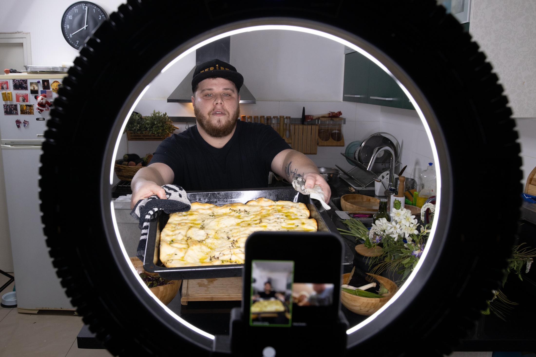 Chef and restaurant owner Shachar Levi, 32, teaches an online cooking class on Zoom in his home...