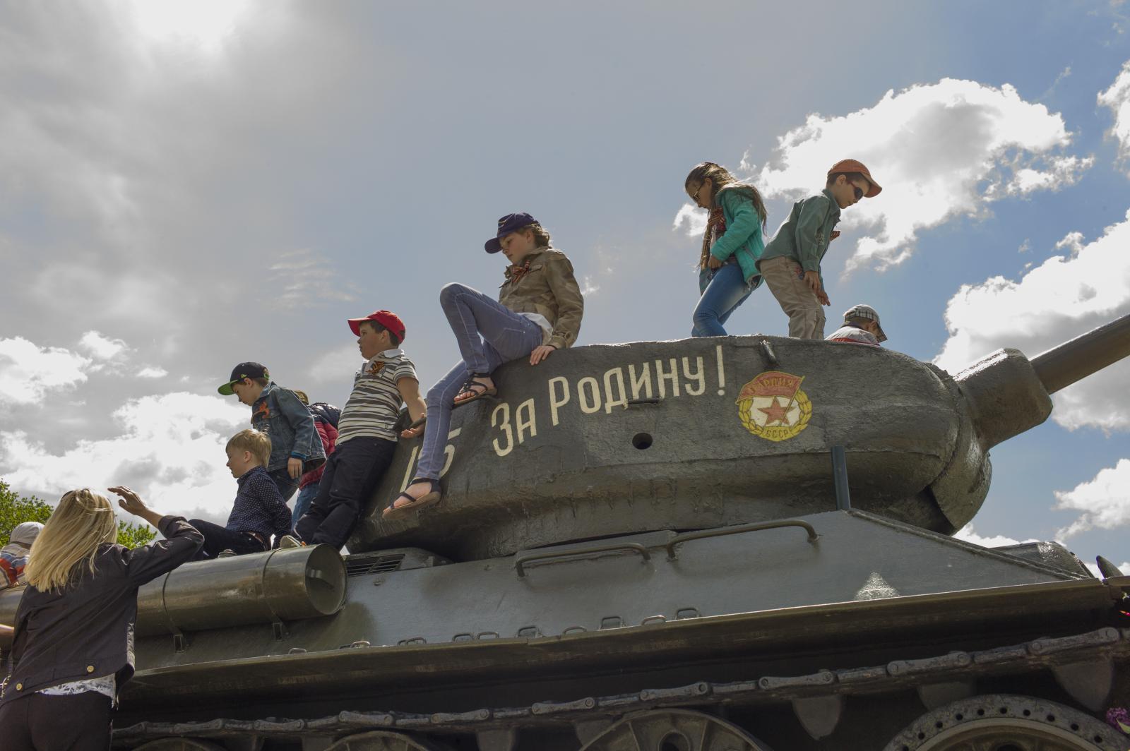 Victory Day in Transnistria -  Kids play on the tank, where a sign reads ...