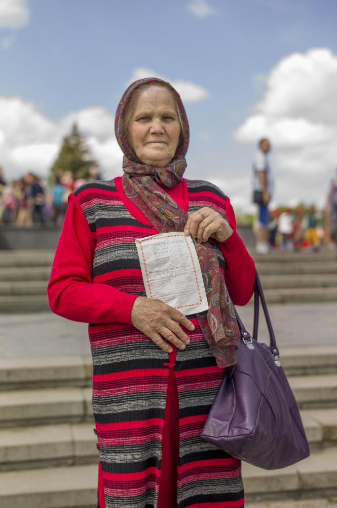 Image from Victory Day in Transnistria -  Alina, the grandmother, stands for a picture with the...