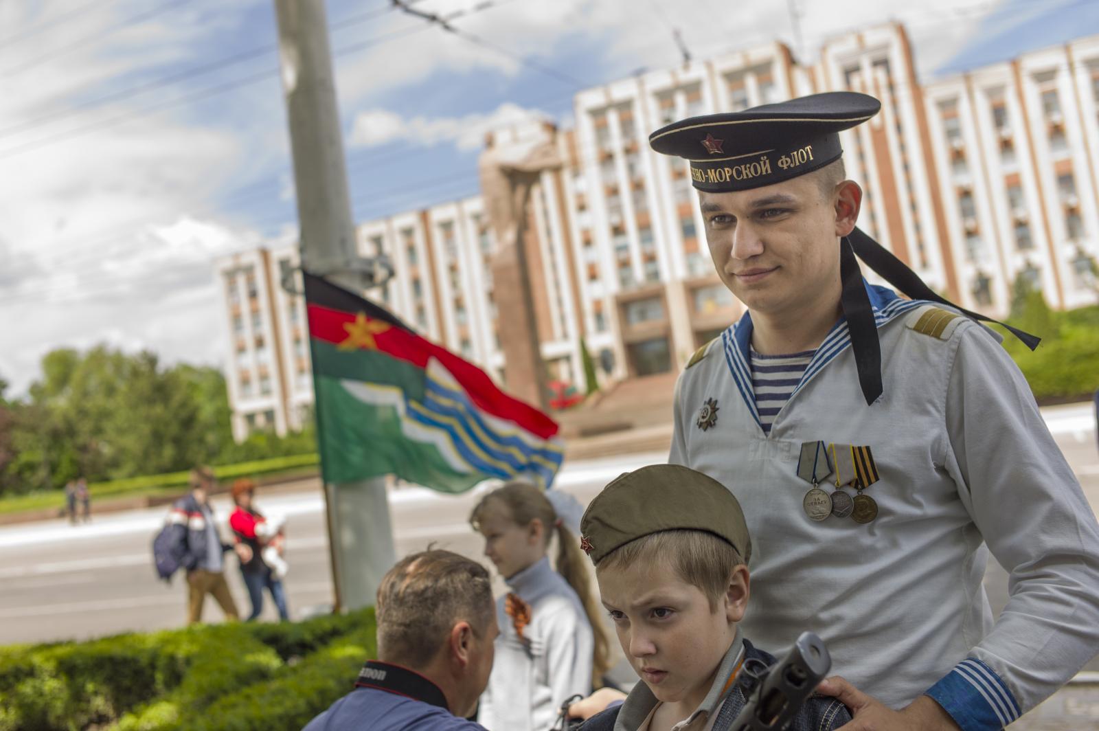 Victory Day in Transnistria -  A soldier wears the marines uniform to attract people to...