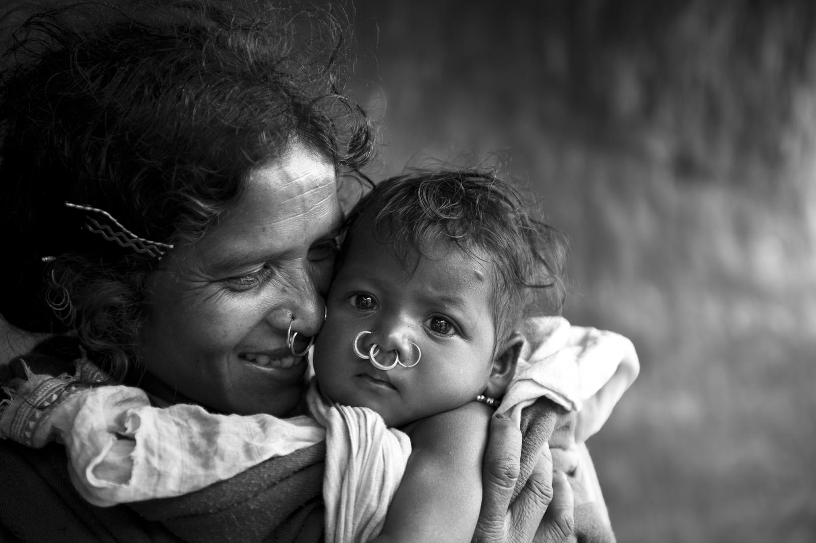 WHEN A MOTHER SMILES, THE WORLD SMILES WITH HER.