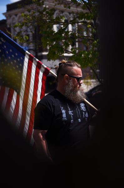 Justin S. carries an American flag at an open-Boone County protest on Thursday, May 7, 2020, at Columbia City Hall. &ldquo;We need to support our community by giving them the opportunity to pay their bills,&rdquo; Justin said. &ldquo;We want our businesses open, we want our people to work, we want our rights to be respected.&rdquo;