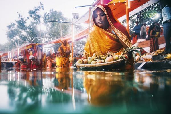 NEPAL, FOREVEREST - Janakpur. A woman brings food offerings into the waters...