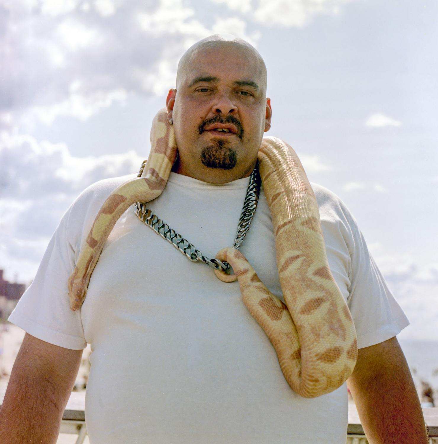 Faces of New York City  - Julio and his albino python at Coney Island, 2019
