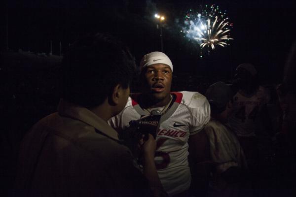 University of New Mexico running back Jhurell Pressley is interviewed by local media after a football game on September 22, 2012.