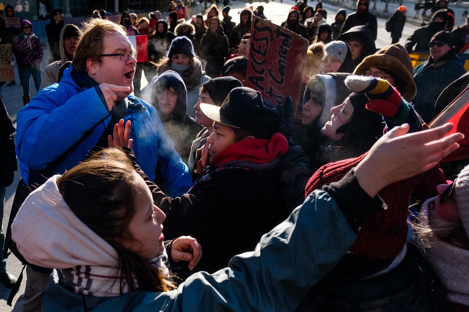 A lone counter protestor confro...ine Project. February 26, 2020.