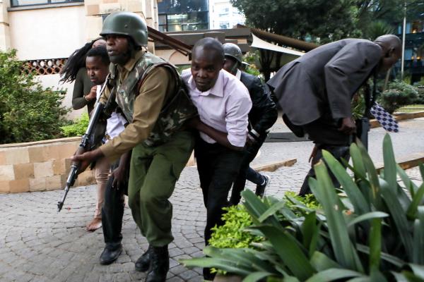 Daniel Irungu | Kenya Nairobi Explosion  - Kenyan police officers rescue victims to safety during an...