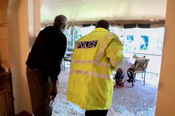 Daniel Irungu | Kenya Nairobi Explosion  - Kenyan police officers take cover as a motionless body...