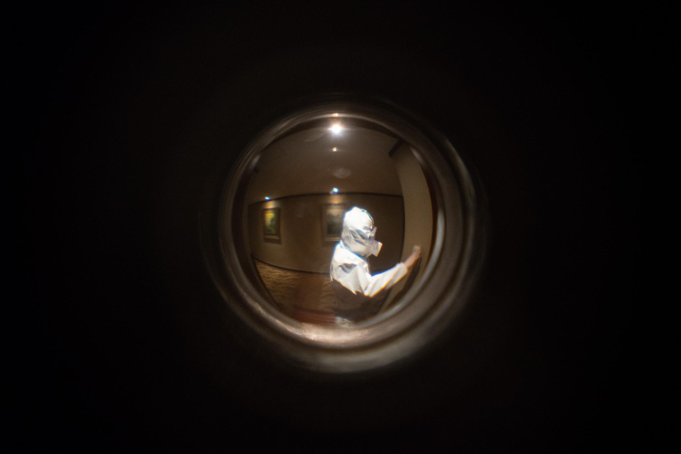 Seen through the peephole: a hotel staff rings my door bell to remind me dinner is left on the low table outside my door.