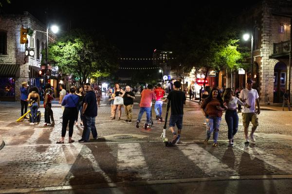Image from Recent - People gather on Sixth Street in downtown on the second...