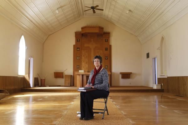 Portraits - Nancy Schlichte sits in the now-stripped Our Lady of the...