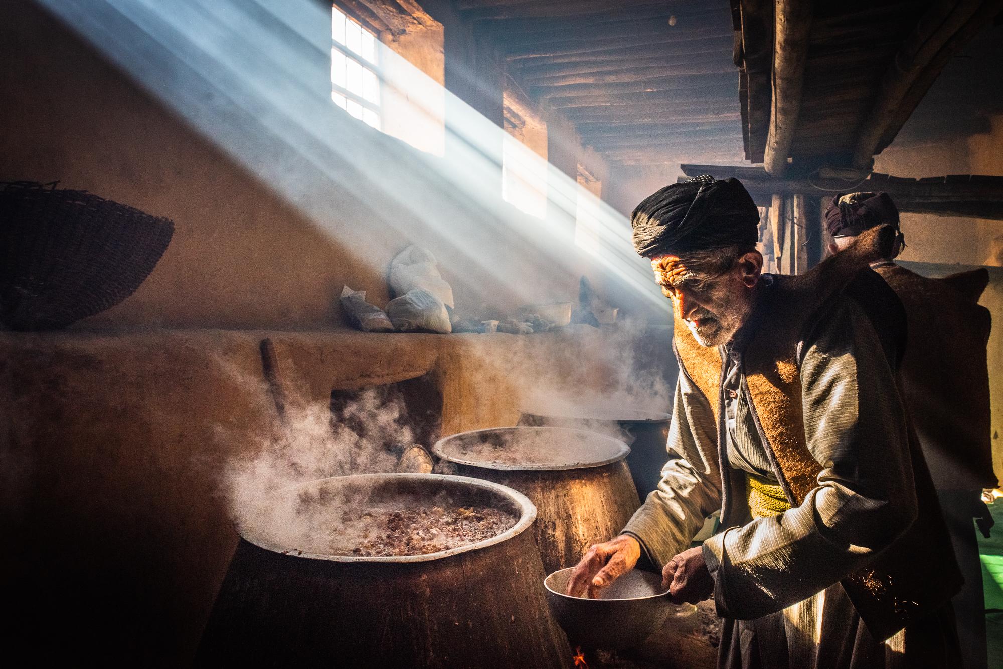 HEWRAMAN-TAKHT, IRAN &ndash; JANUARY 31, 2019: An old Kurdish man preparing a traditional...
