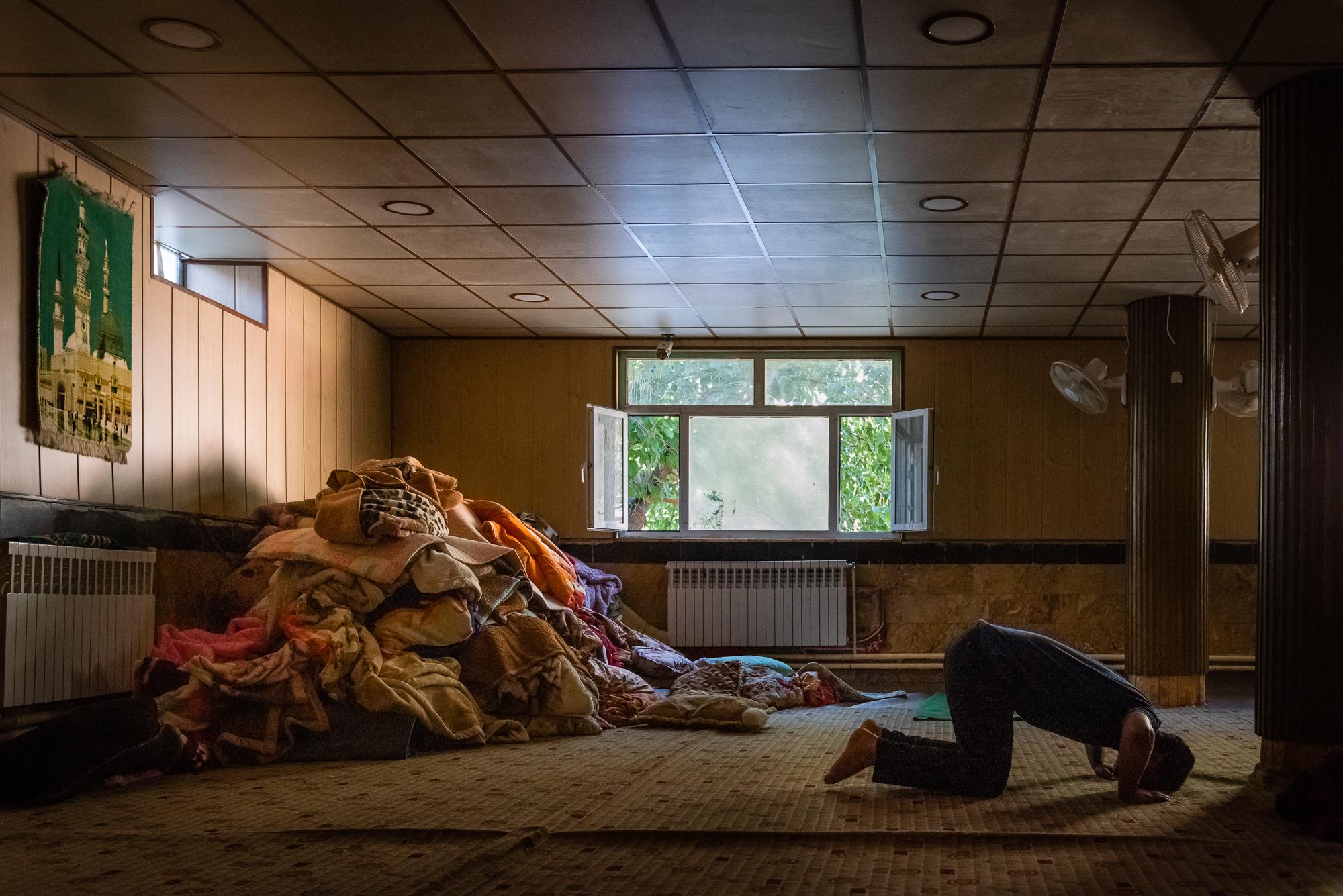 BYARA, IRAQI KURDISTAN &ndash; SEPTEMBER 13, 2019: A man praying inside the sleeping hall of...