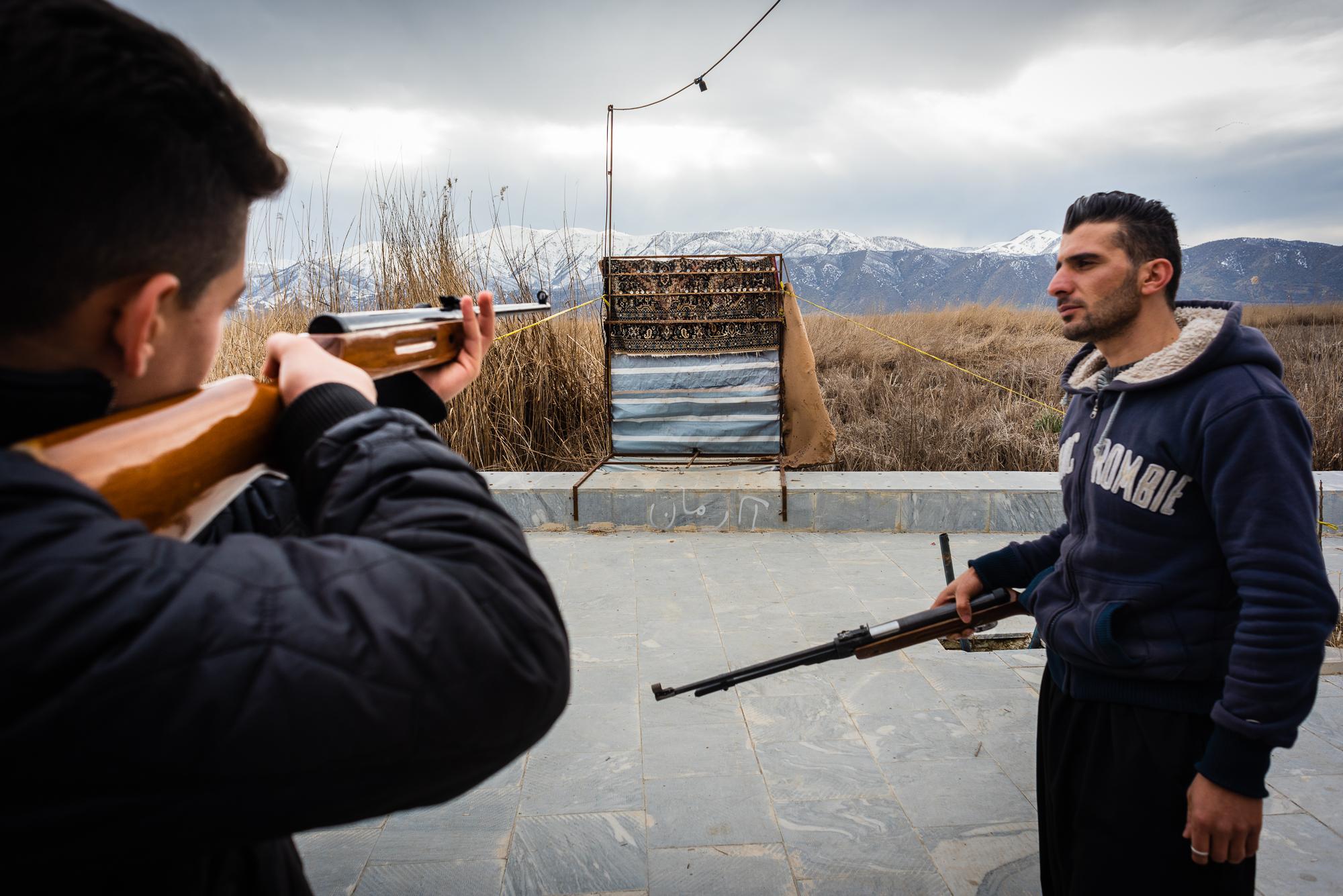 MARIVAN, IRAN &ndash; FEBRUARY 2, 2019: Young Kurds shooting air guns on the promenade along...