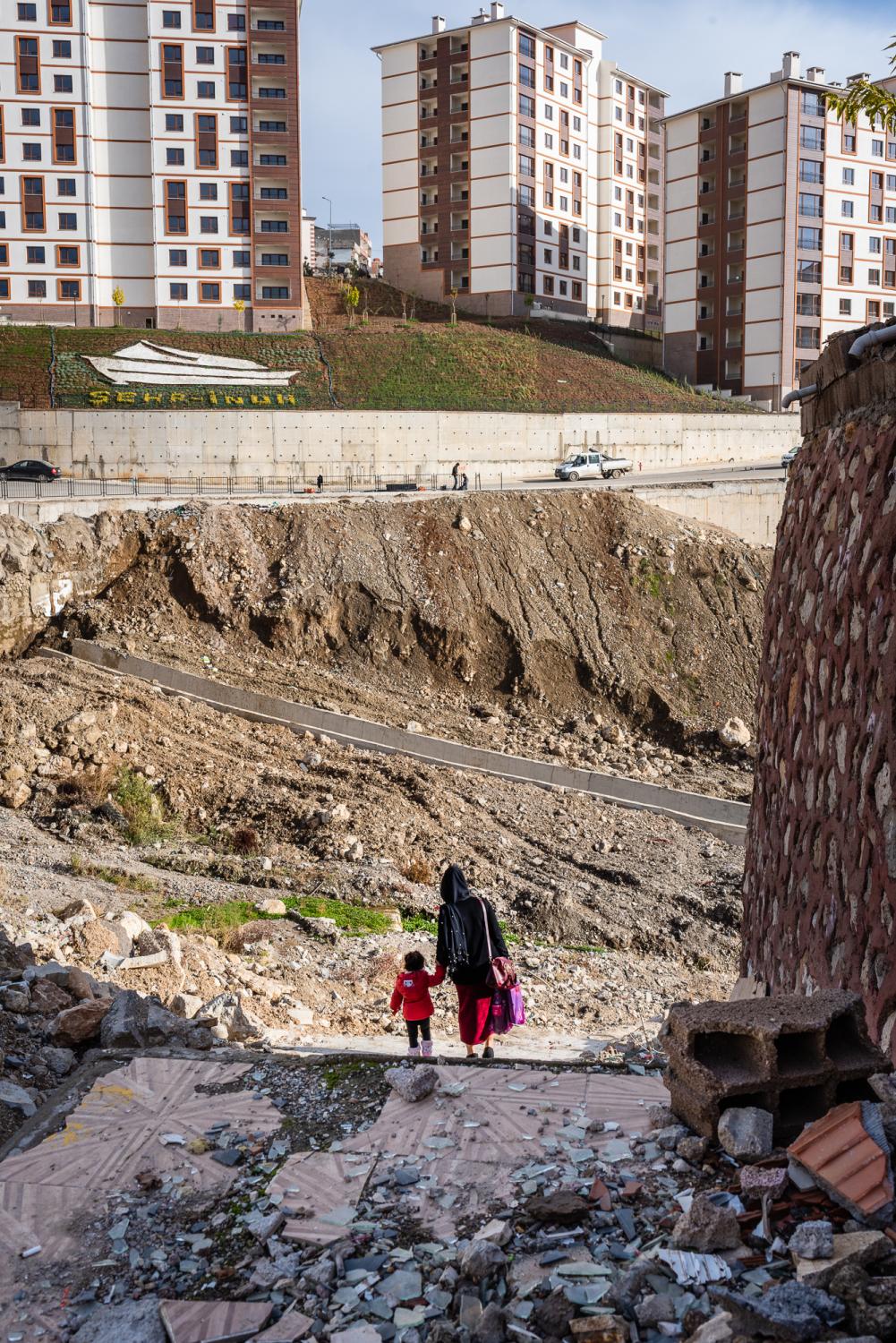 SIRNAK, TURKEY &ndash; NOVEMBER 20, 2018: A mother and her child walking pass a residential...