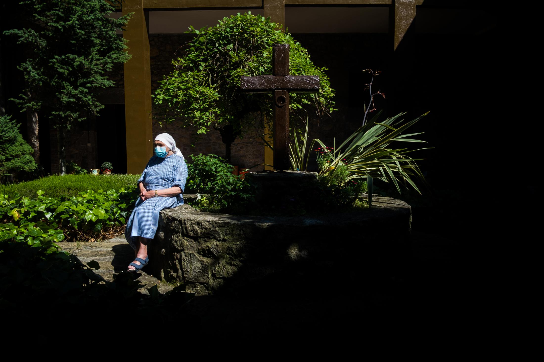 AN OASIS INSIDE THE PANDEMIC -   Wearing her habit, Sister Genoveva rests in the central...