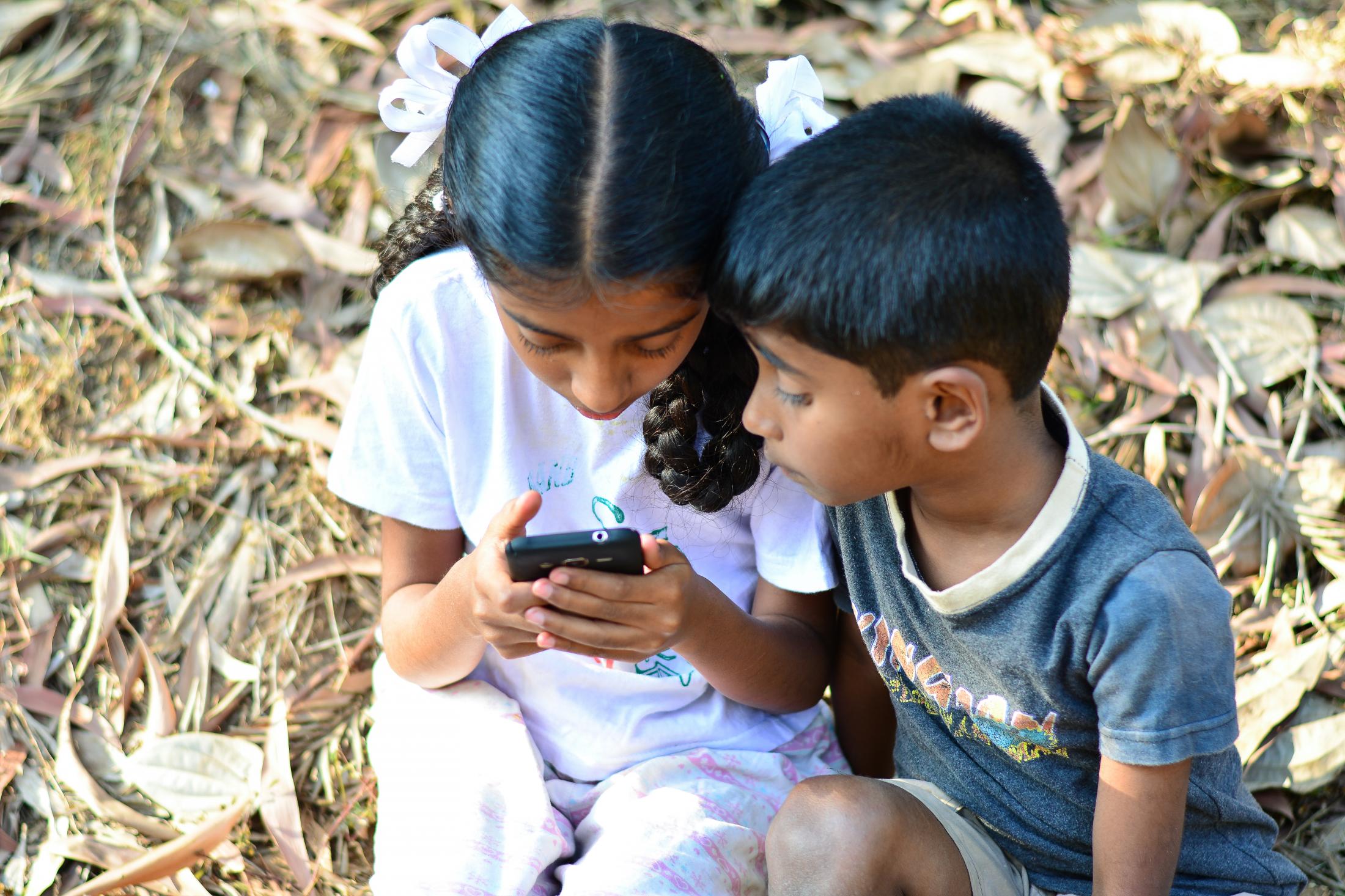 Swami&rsquo;s daughter Rashmi and son Vinay playing games on a phone after returning from school. Swamy is very fond of education. He could not complete graduation due to circumstances at home but hopes to provide his children with it.