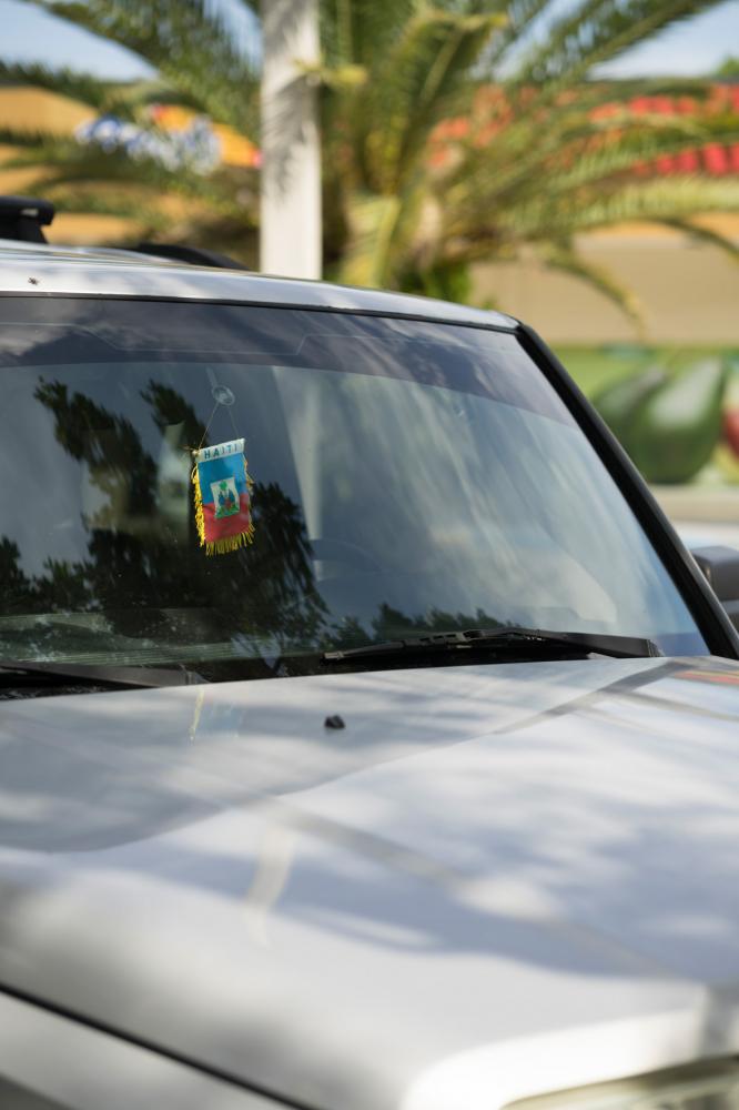 Image from Miami Bites - A pennant with the Haitian flag hangs on the rear-view...