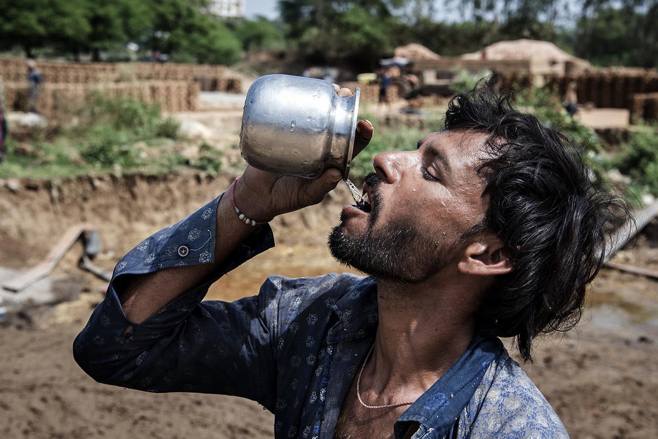 Migrant workers in Bhopal - A brick field worker drinking polluted water near Kolhua