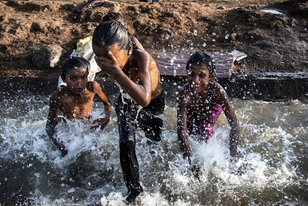 Migrant workers in Bhopal - Migrant children playing in a polluted water near Adampur...