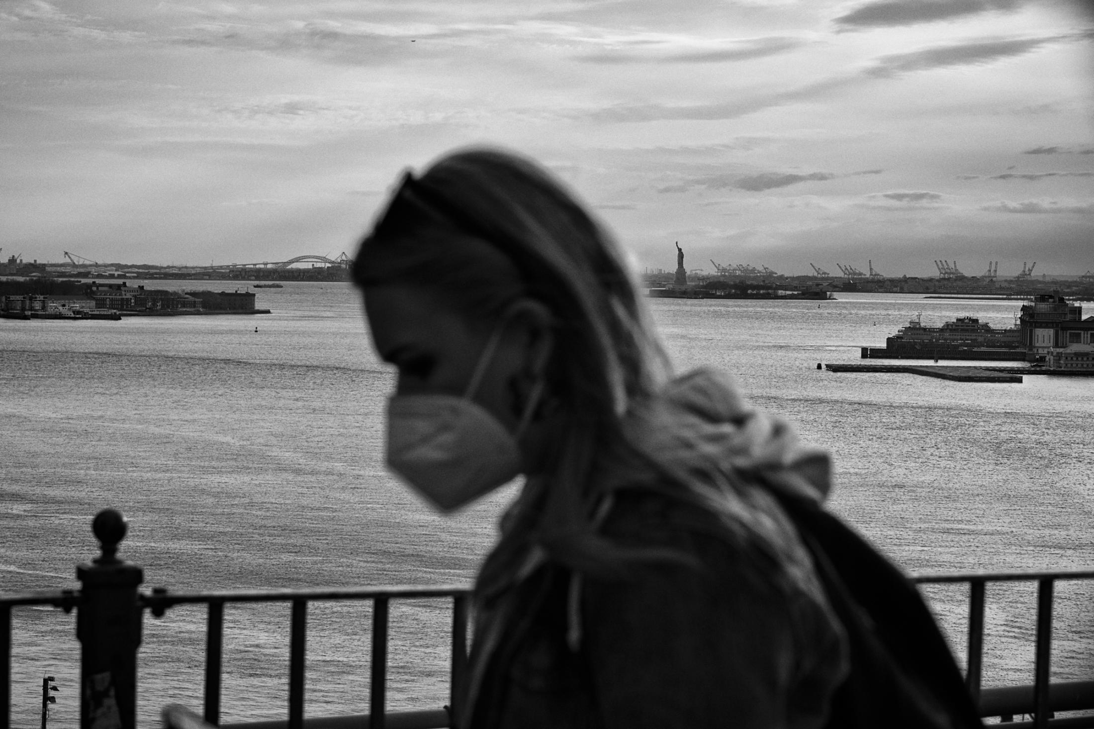 Dire Silence: NYC in Pandemic -  A passer by on Brooklyn Bridge, Brooklyn, New York. Apr....
