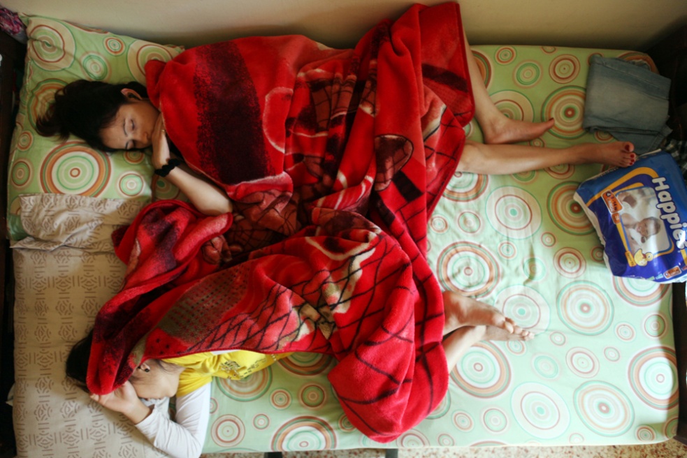 No, Madam - Two Nepalese ladies sleep in one bed, the flat they live...