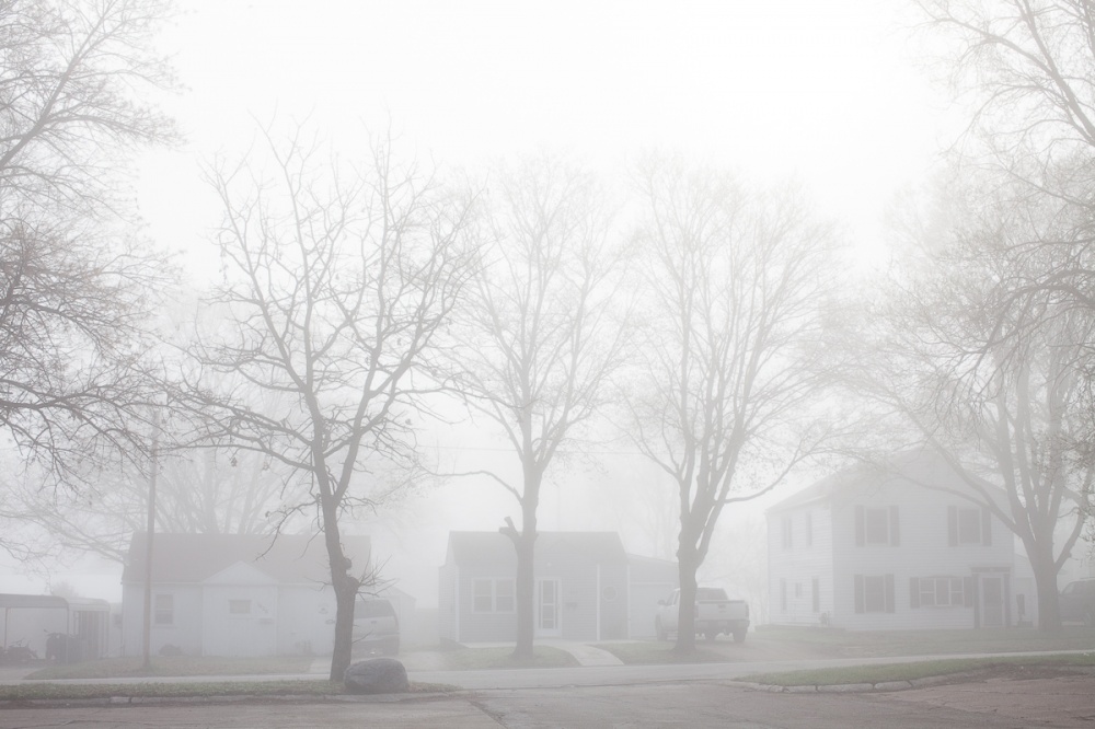 Morning fog obscures houses on ...h 23, 2012 in Webster City, IA.