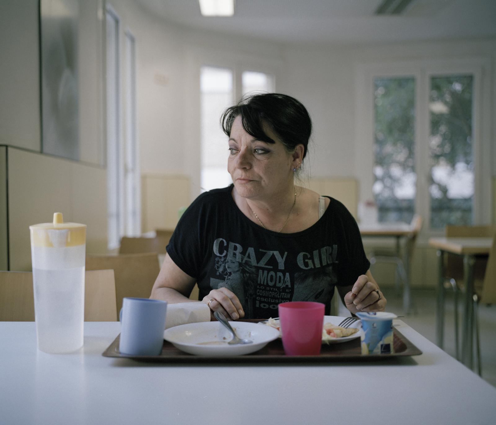 Carmen Gil, unemployed, eats lunch a a government canteen in Barcelona where meals are provided for those in need. She squats in a flat with her daughter and granddaughter where they all live with &euro;426 monthly income support from the government.
