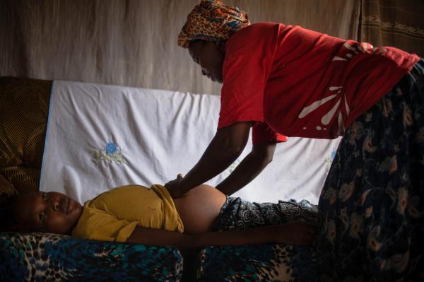 Image from  Esther Mbabazi | The Acquaintance - A Traditional Birth Attendant checks up on a pregnant...