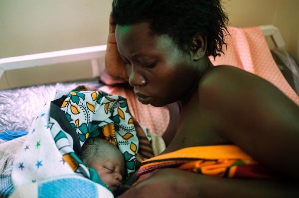 Image from  Esther Mbabazi | The Acquaintance - A mother breast feeds her newborn baby in the recovery...