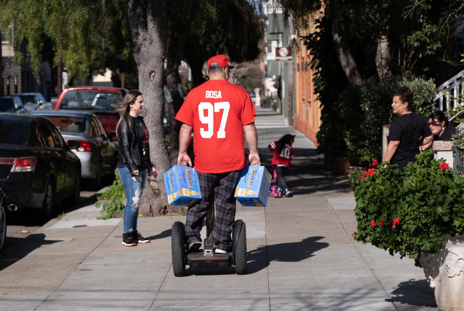 Image from A Scarlet and Gold Neighborhood - JohnMarksman transports beer on his segway as he and his...