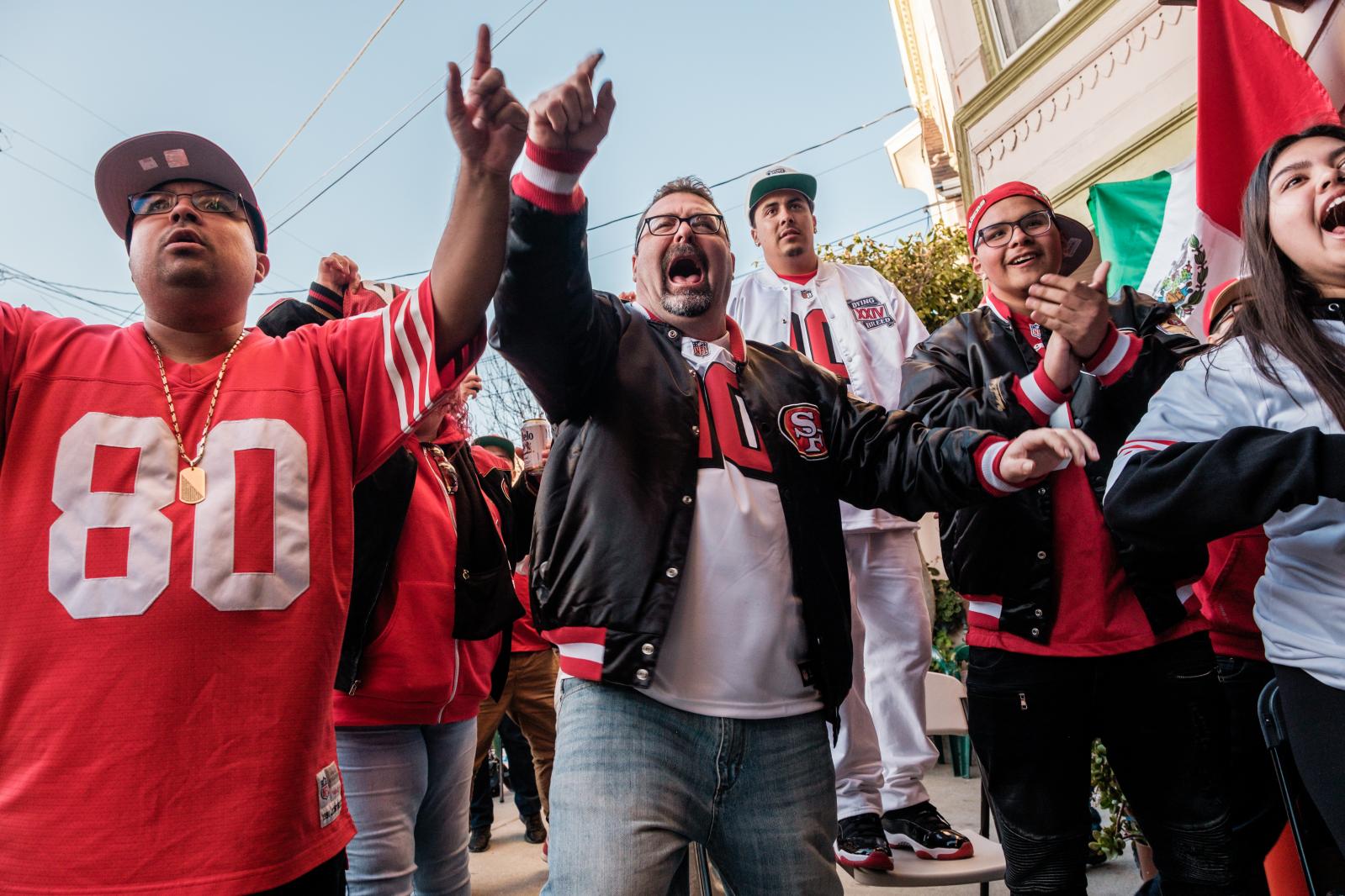 Image from A Scarlet and Gold Neighborhood - John Gallardo (center) celebrates with a neighbors after...