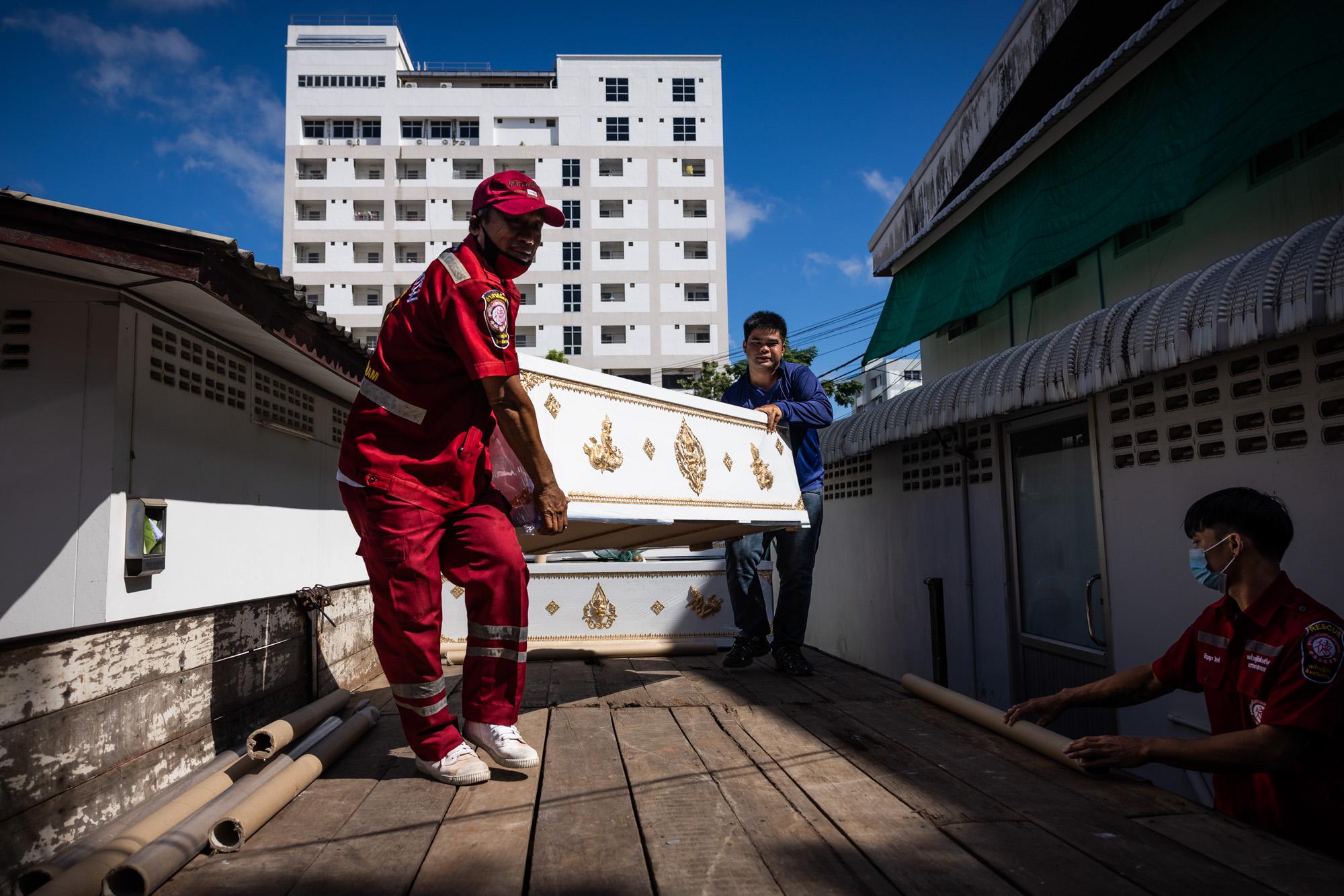 Shooting in Nong Bua Lamphu: The New York Times - Volunteer rescue workers unload a coffin for victims of...