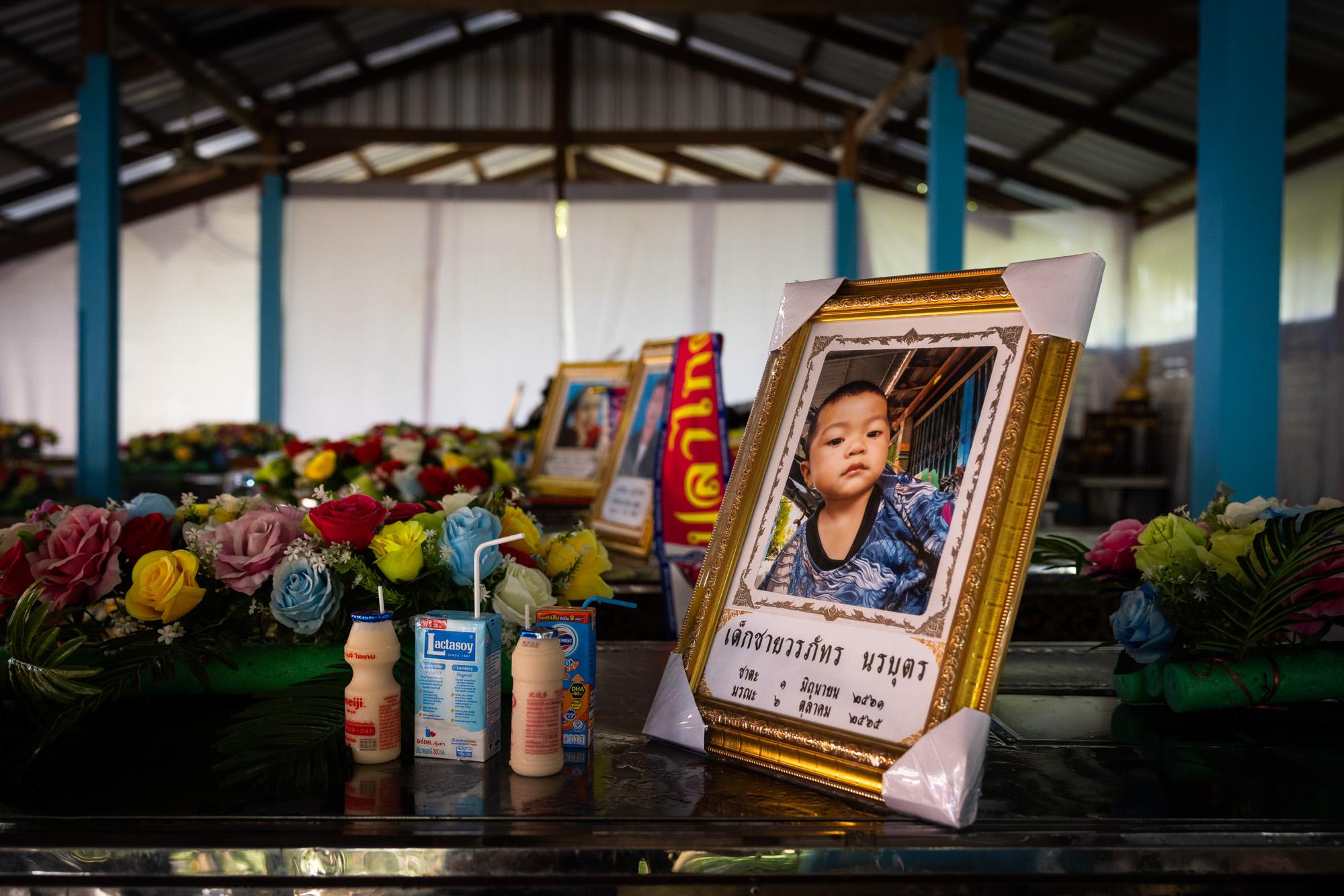Shooting in Nong Bua Lamphu: The New York Times - A portrait of one of the child victims is seen on top of...