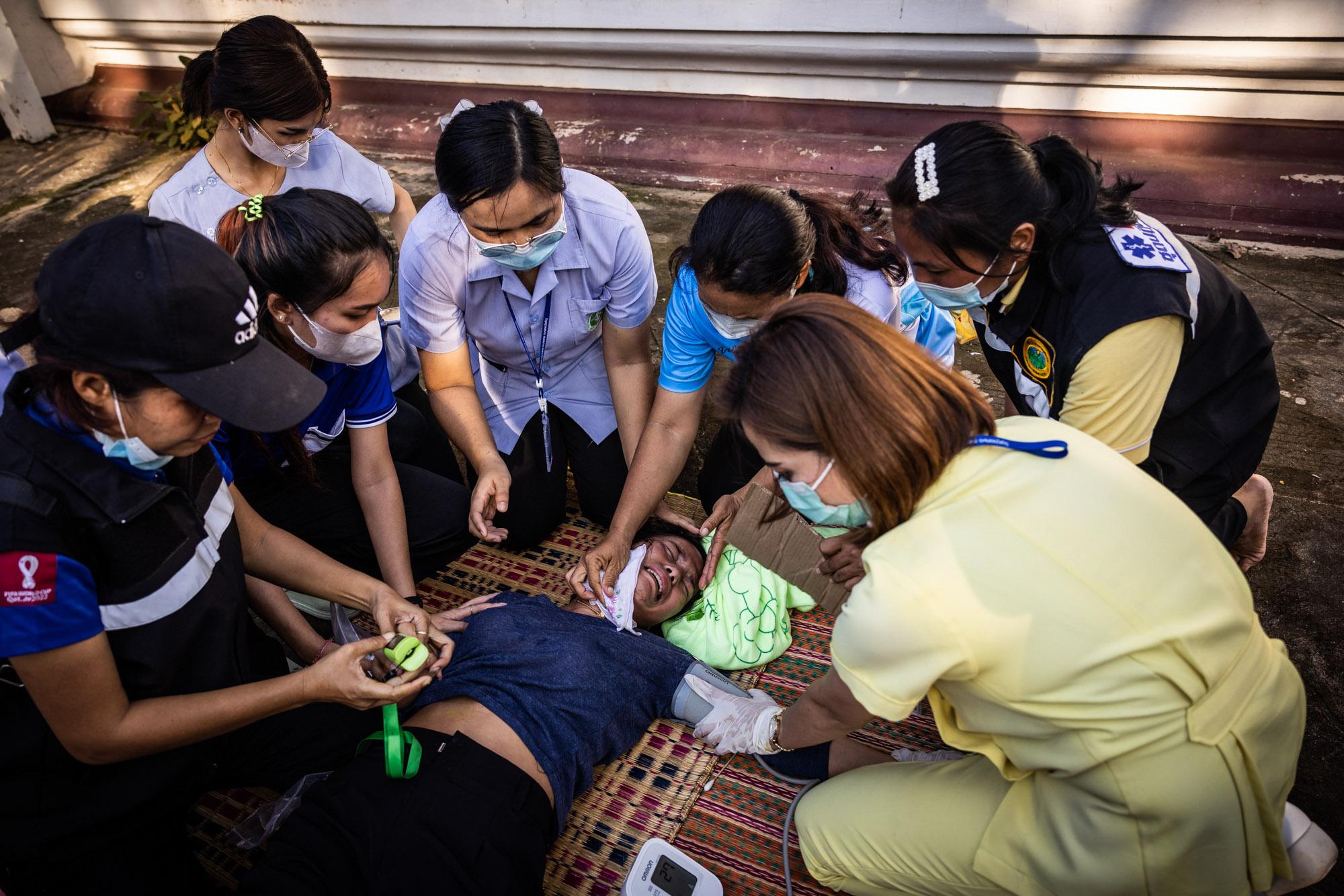 Shooting in Nong Bua Lamphu: The New York Times - A mourner who collapsed is assisted by volunteer health...