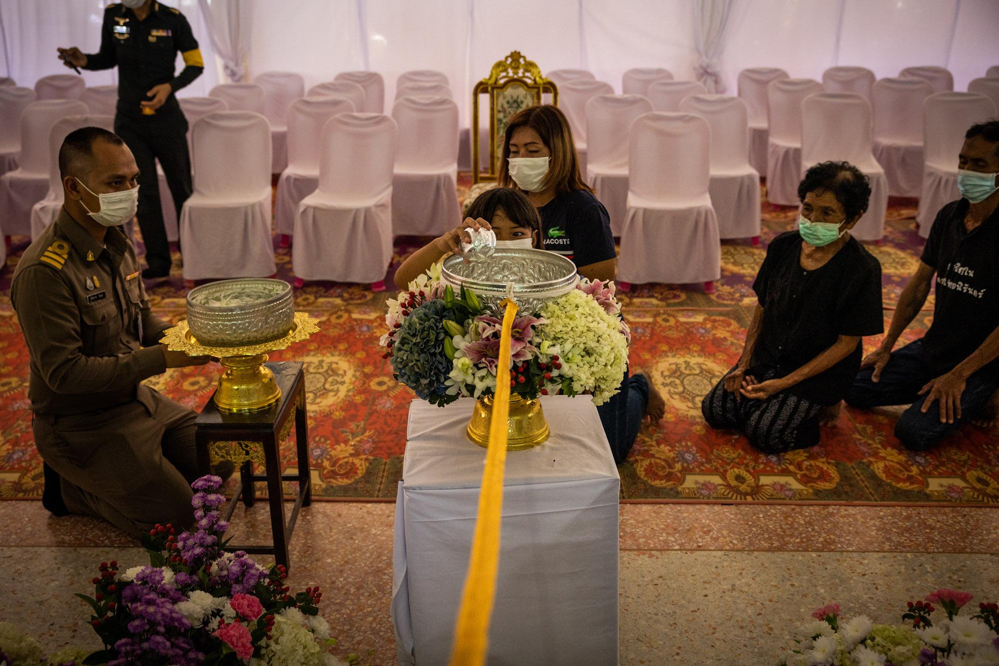 Shooting in Nong Bua Lamphu: The New York Times - A young girl participates in a purification ceremony for...