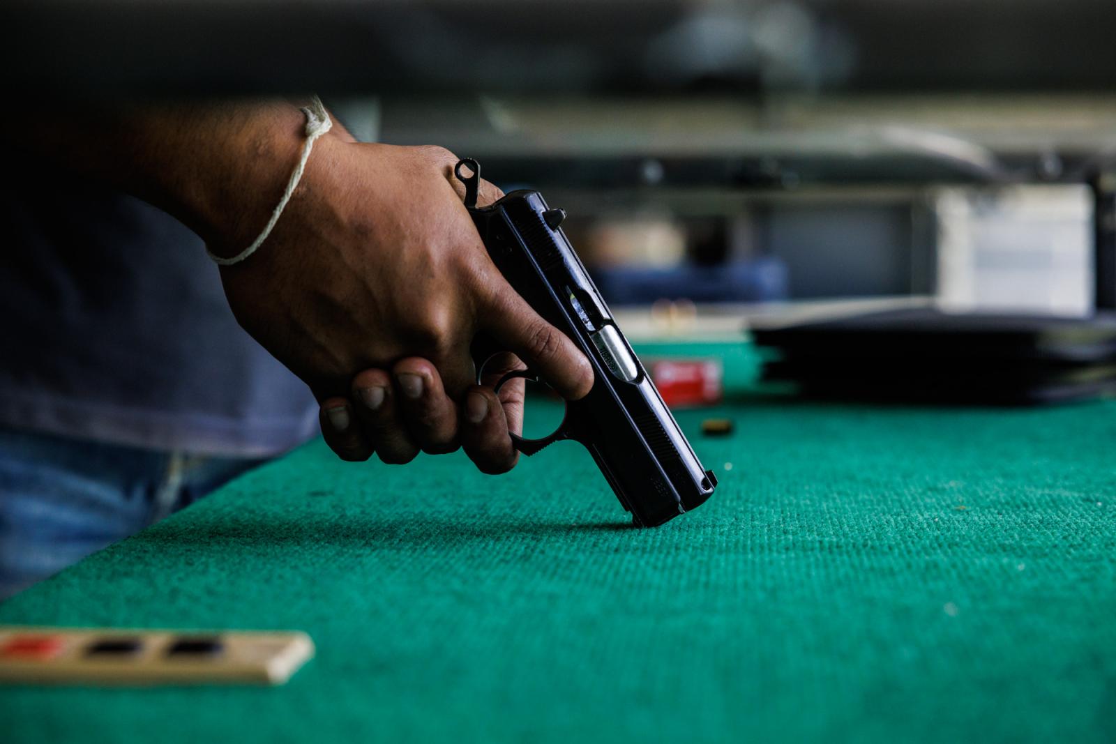 A man holds a hand gun at a sho...ngkok, Thailand, June 11, 2023.