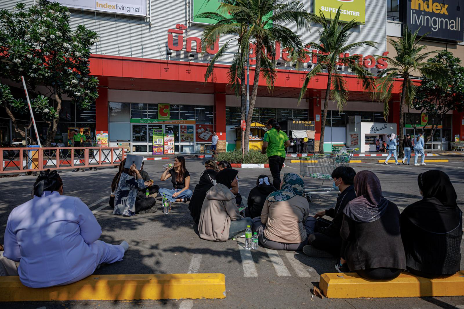 People sit in the parking lot o...gkok, Thailand, March 28, 2025.